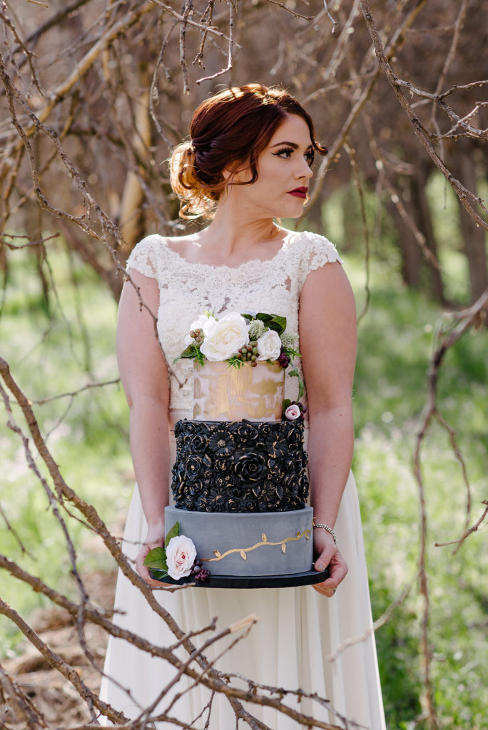Bride holding wedding cake